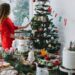 girl in red dress decorate the tree